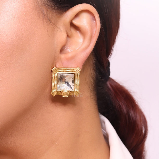 Square solitaires in gold boundaries with medusa