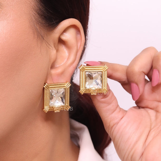 Square solitaires in gold boundaries with medusa