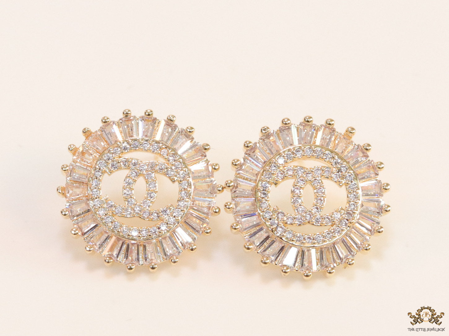 Round gold studs lined with cz baguettes and twin C cz motif centre