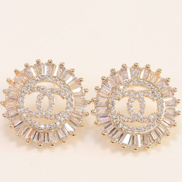 Round gold studs lined with cz baguettes and twin C cz motif centre