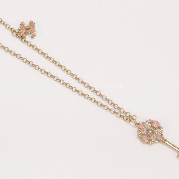Golden chain necklace with pink clovers studded key pendant