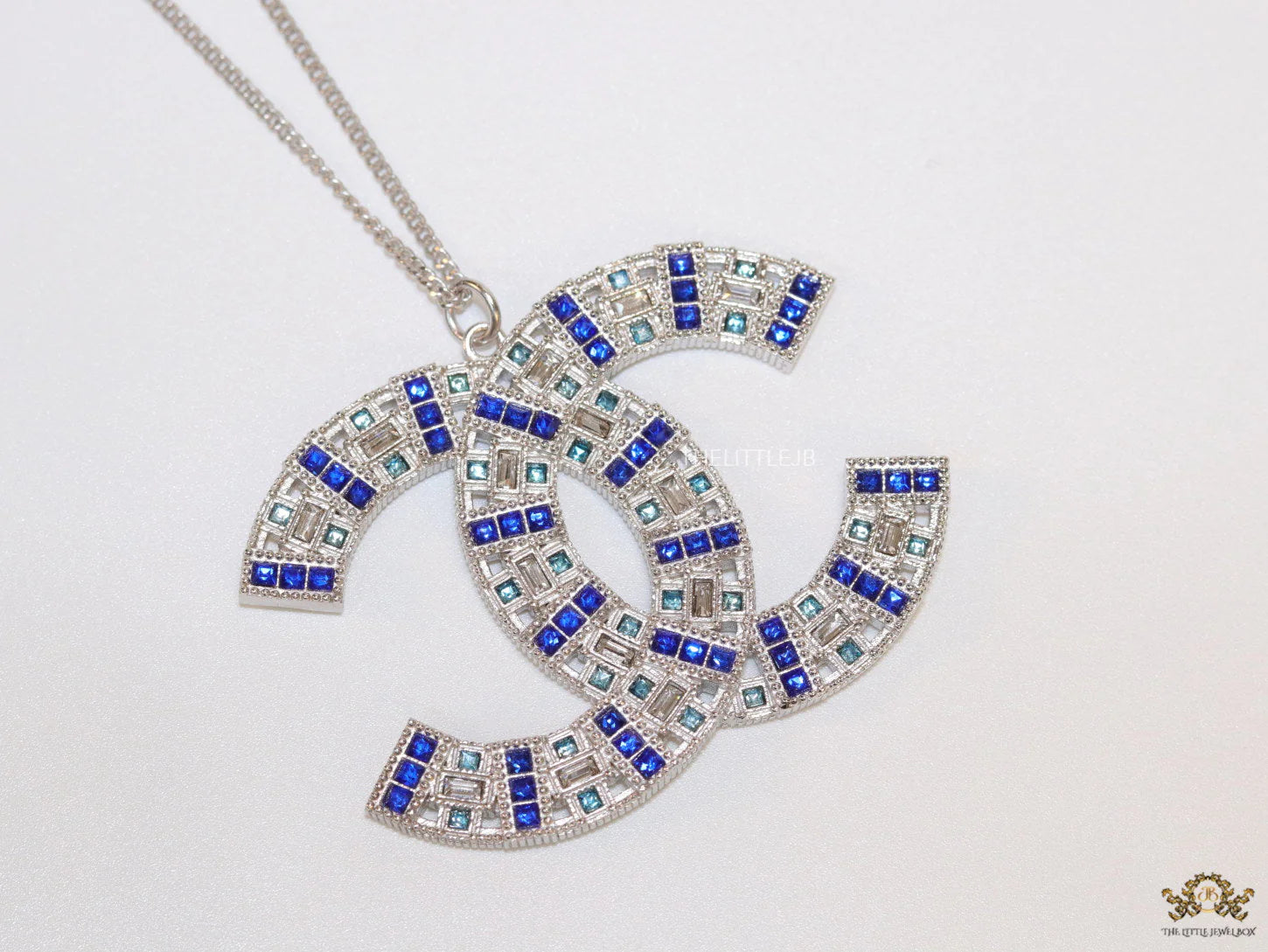 Platinum chain alphabet necklace with coloured cz