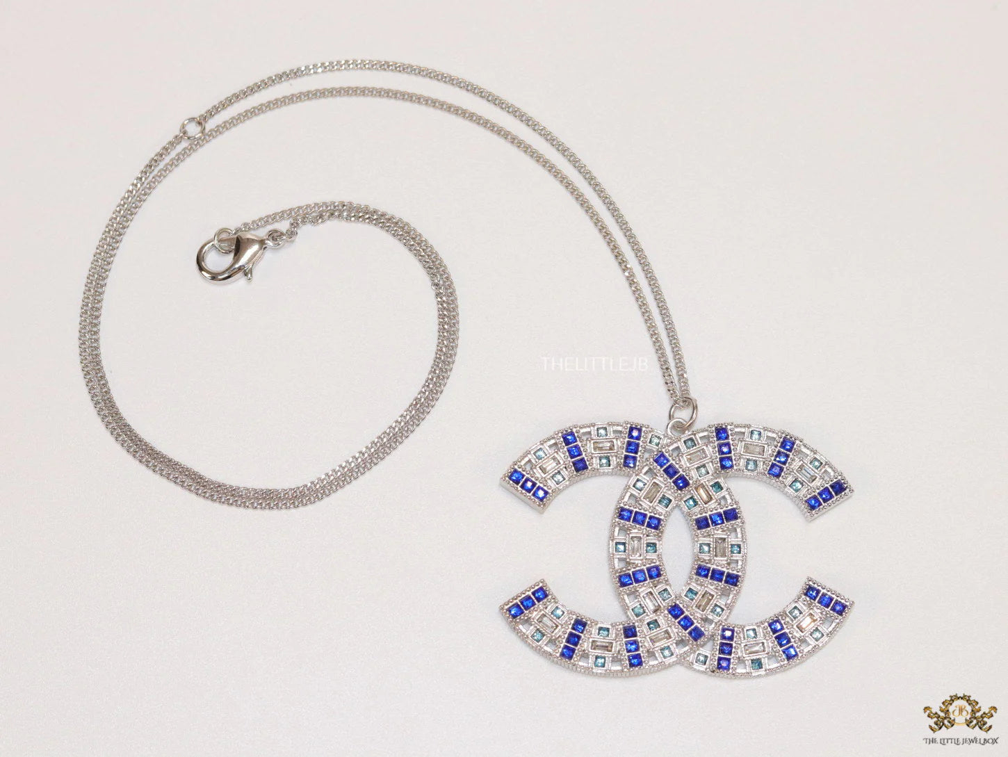 Platinum chain alphabet necklace with coloured cz