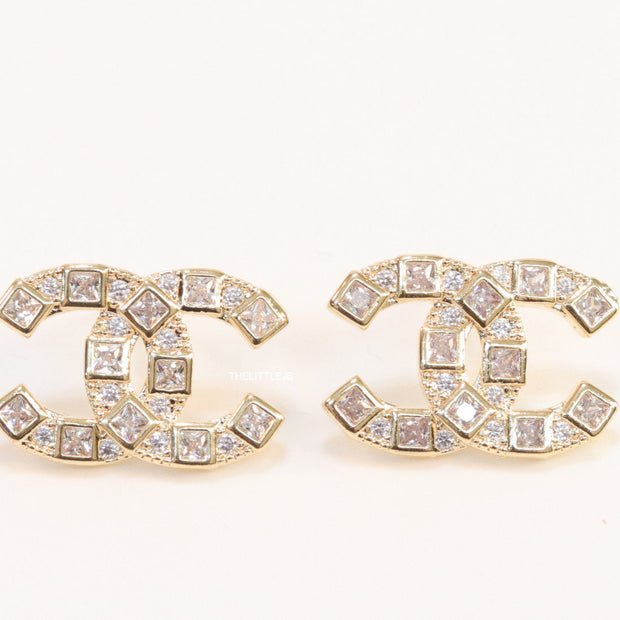 Golden twin C motif studs with fancy cut cz