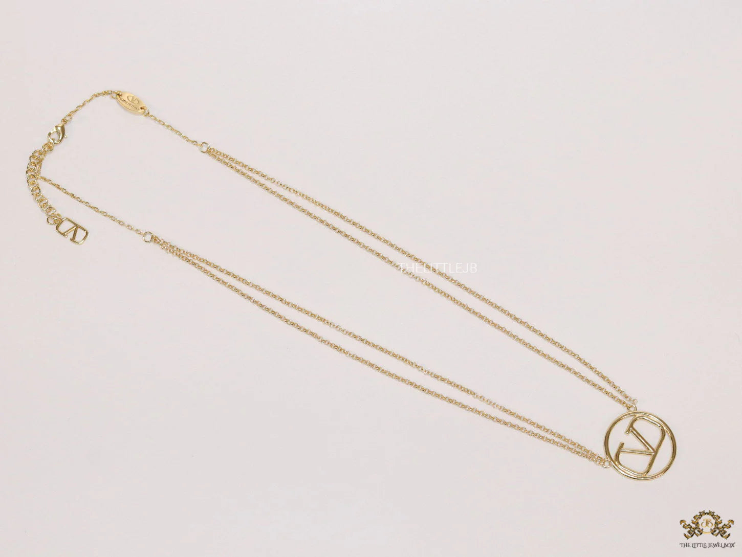 Dual chain golden necklace with alphabet pendant