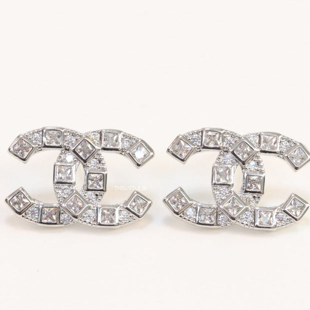 Platinum plated twin C motif studs with fancy cut cz
