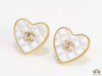 White textured heart shaped studs with twin C motif in golden finish