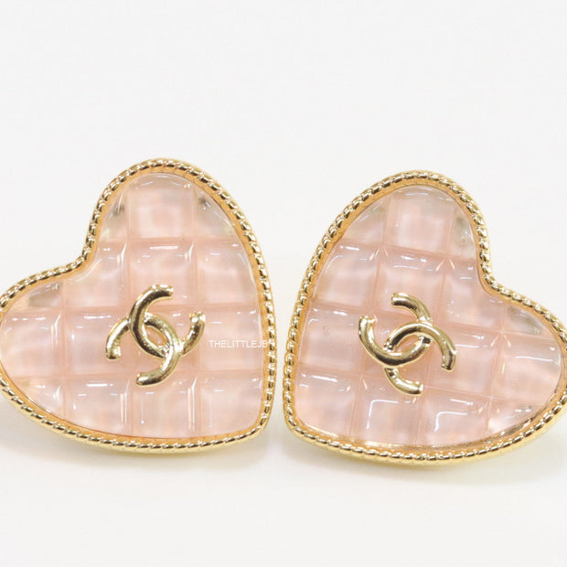Light pink textured heart shaped studs with twin C motif in golden finish