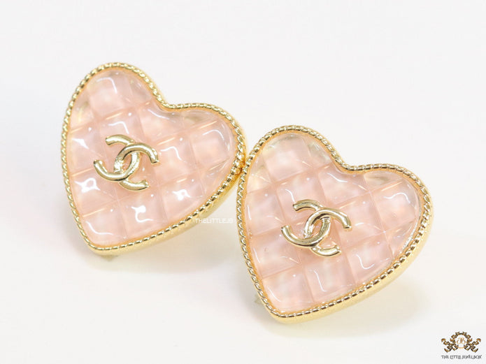 Light pink textured heart shaped studs with twin C motif in golden finish