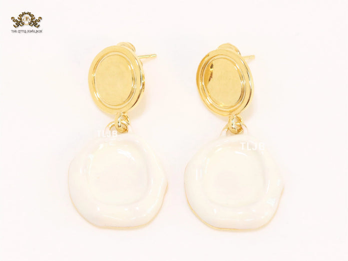 White enamel and gold earrings
