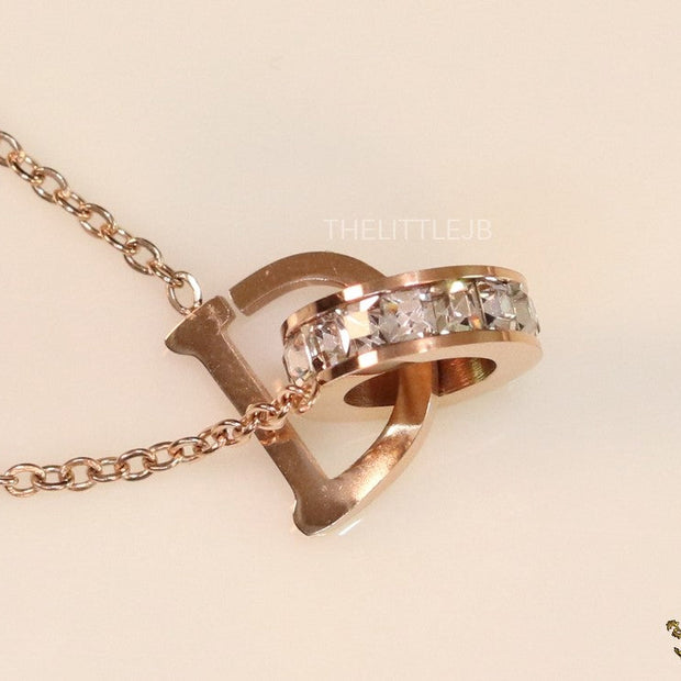 Rose gold plated D initial necklace with interlocking cz ring