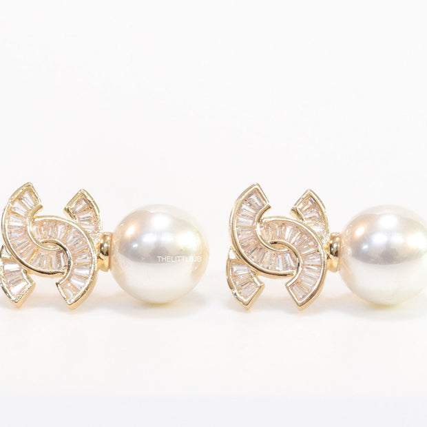 Golden cz baguettes studded twin C motif stud with pearl drop