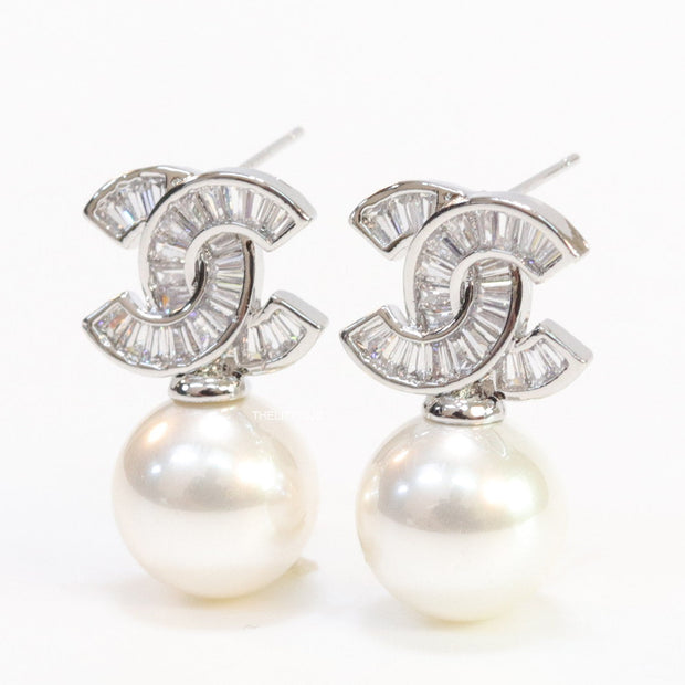 Platinum cz baguettes studded twin C motif stud with pearl drop