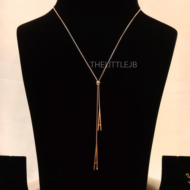 A initial sling necklace in gold finish