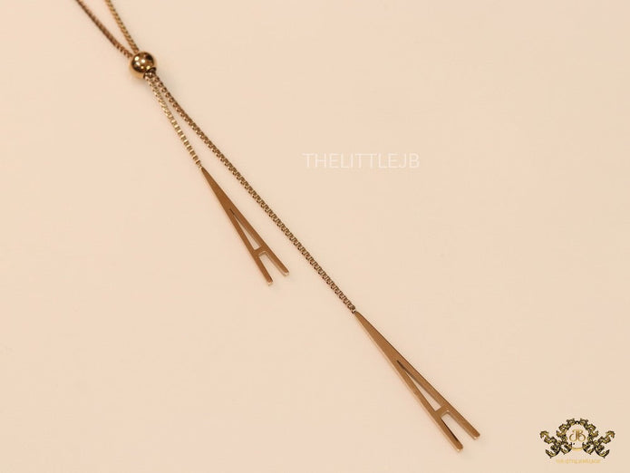 A initial sling necklace in gold finish