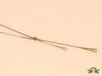 A initial sling necklace in gold finish