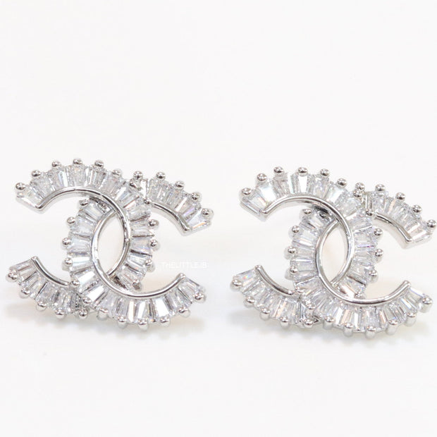 Platinum plated twin C motif studs in cz baguettes
