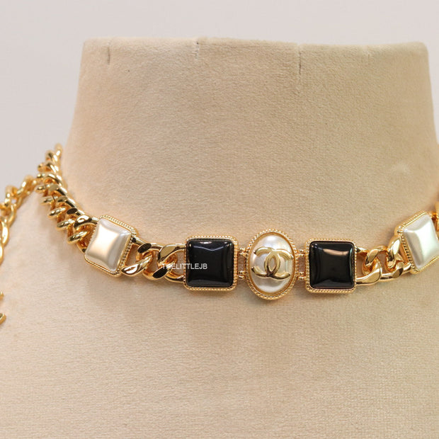 Gold plated link chain choker with MOP and black stone units.