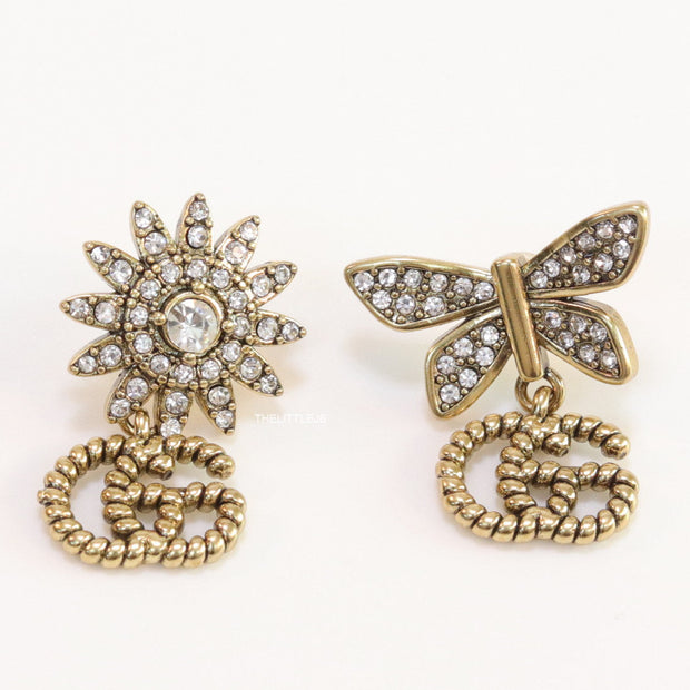 Flower and butterfly cz earrings in antique gold with twin G drops