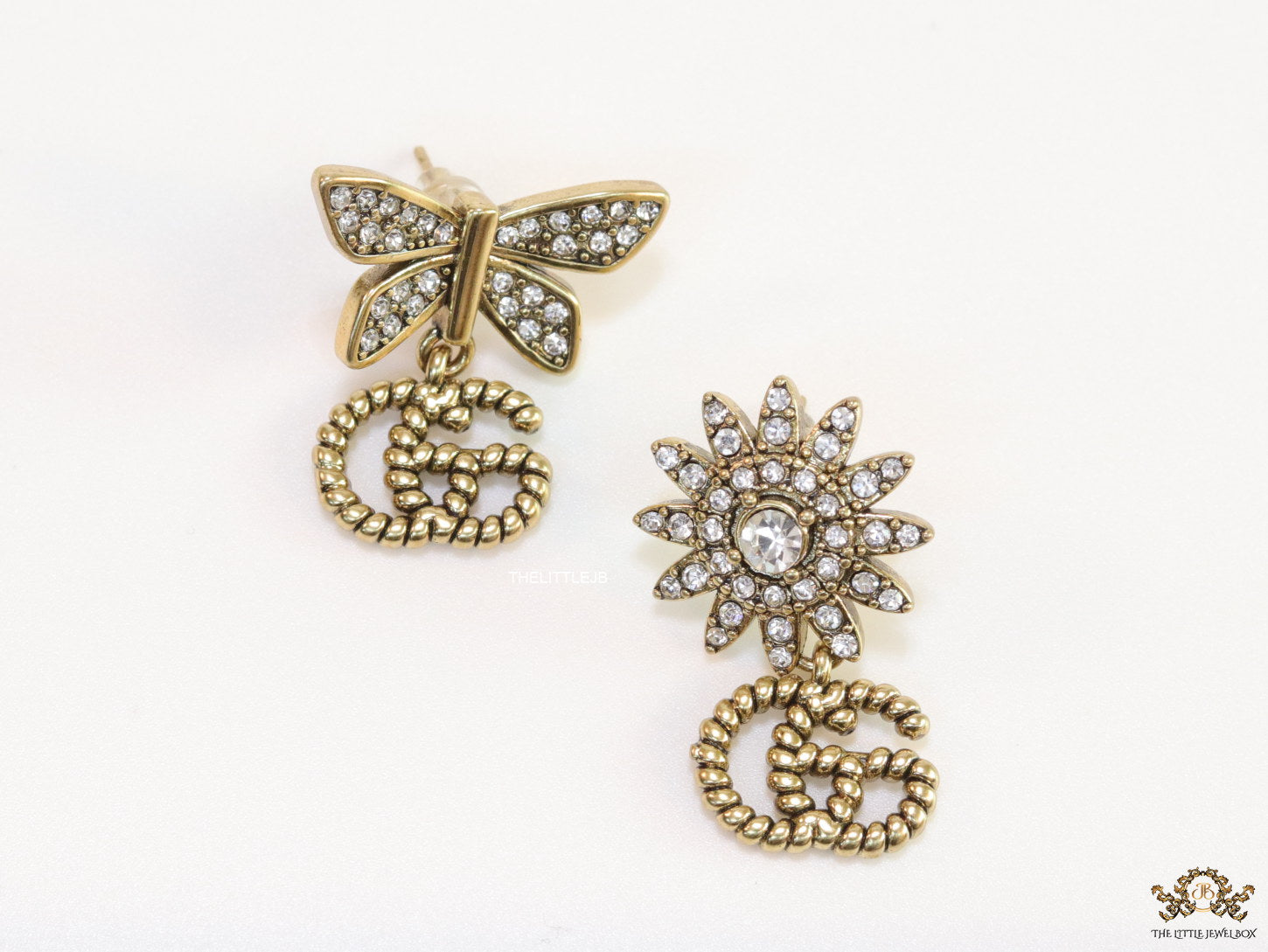 Flower and butterfly cz earrings in antique gold with twin G drops