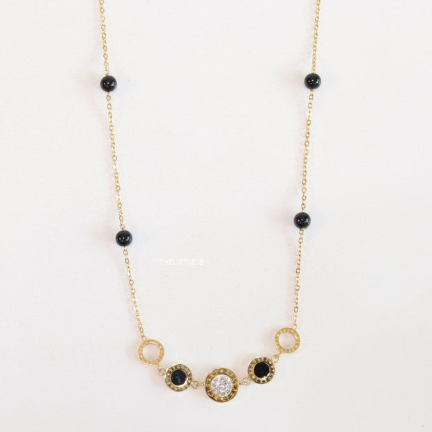 Golden chain necklace with black beads and golden alphabet discs, cz and more