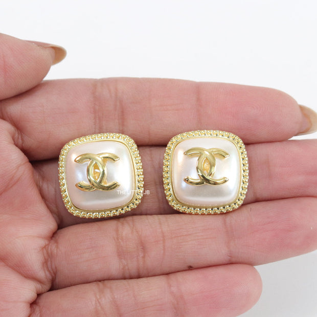 Twin C motif square studs in golden and MOP finish
