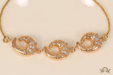 Gold plated sling bracelet with snake motifs