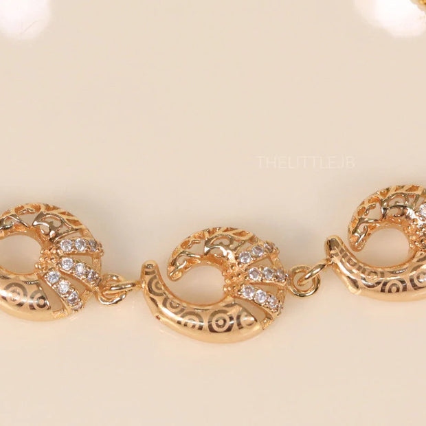 Gold plated sling bracelet with snake motifs