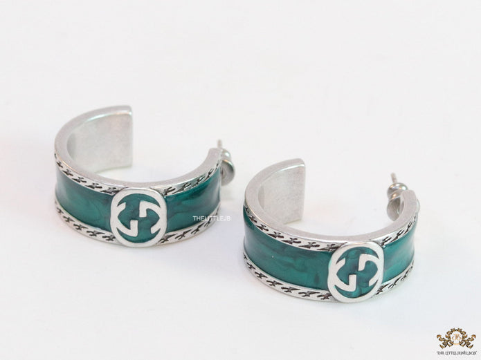 Blue green platinum studs with twin G motif