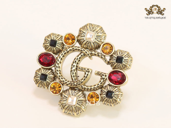 Double G embossed rustic brooch with multi coloured stones