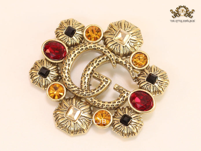 Double G embossed rustic brooch with multi coloured stones
