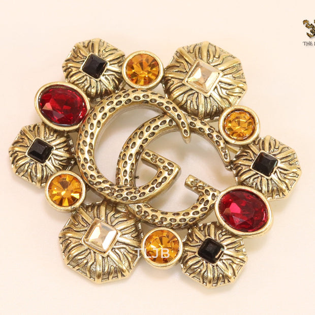 Double G embossed rustic brooch with multi coloured stones