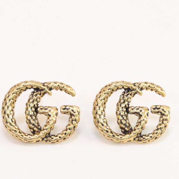 Double G motif studs with woven basket texture in antique gold finish