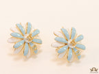 Off-white and soft blue daisy studs with golden details twin alphabet double C motif.