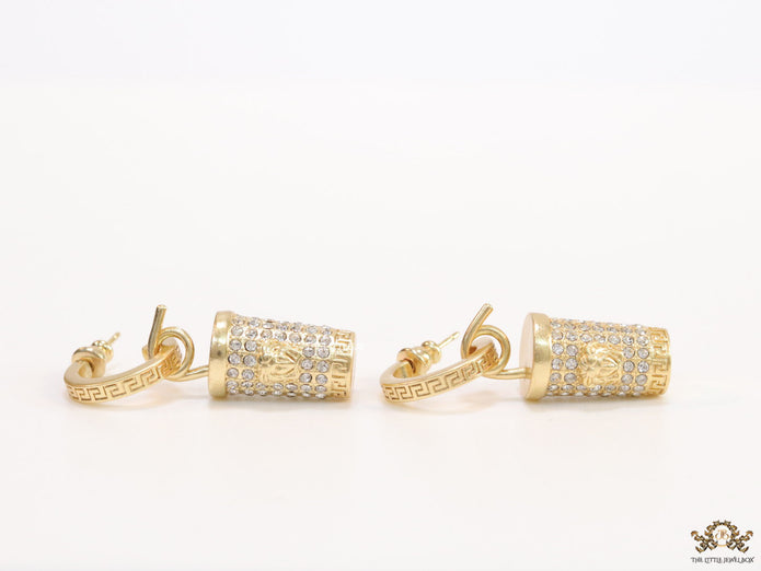 Gold plated hoop with cubic zirconia and 3d golden Medusa motif on cylidrical drop.