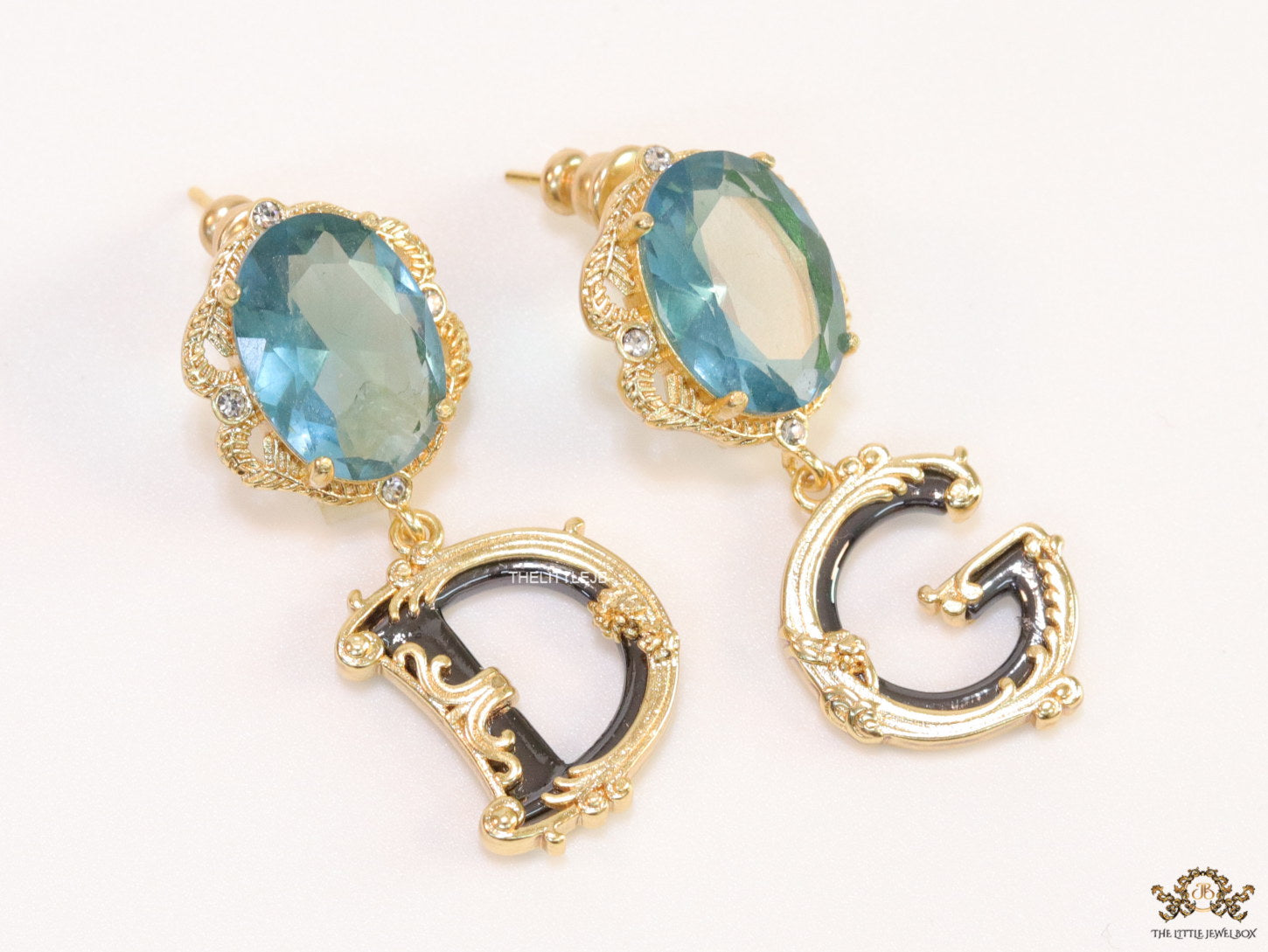 Semi-precious blue stone with gold plated detailed with black and golden alphabet drop