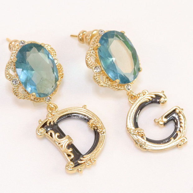 Semi-precious blue stone with gold plated detailed with black and golden alphabet drop
