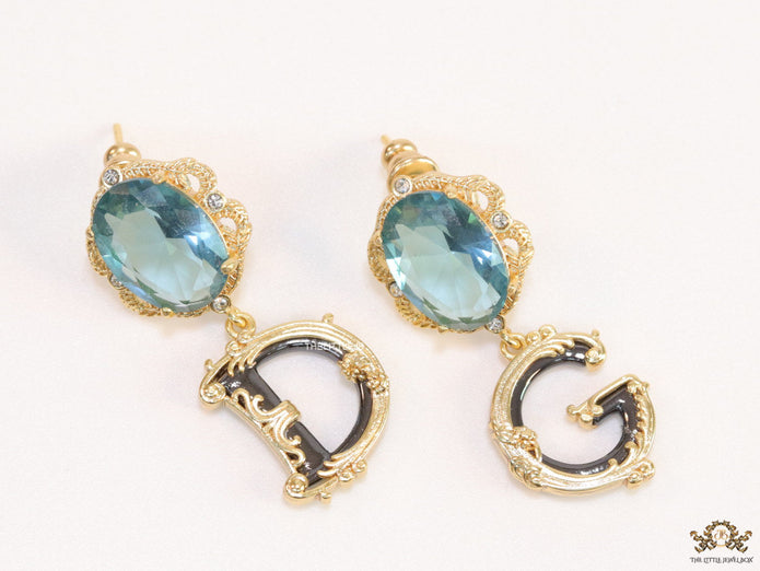 Semi-precious blue stone with gold plated detailed with black and golden alphabet drop