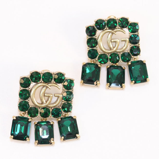 Emerald Green stone studs with gold plated double G motif and emerald green stone drop