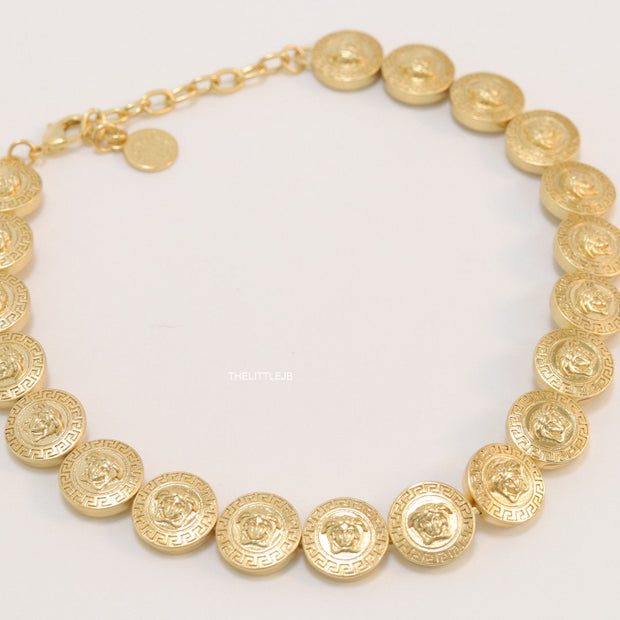 Gold plated embossed Medusa motif on gold circle base necklace