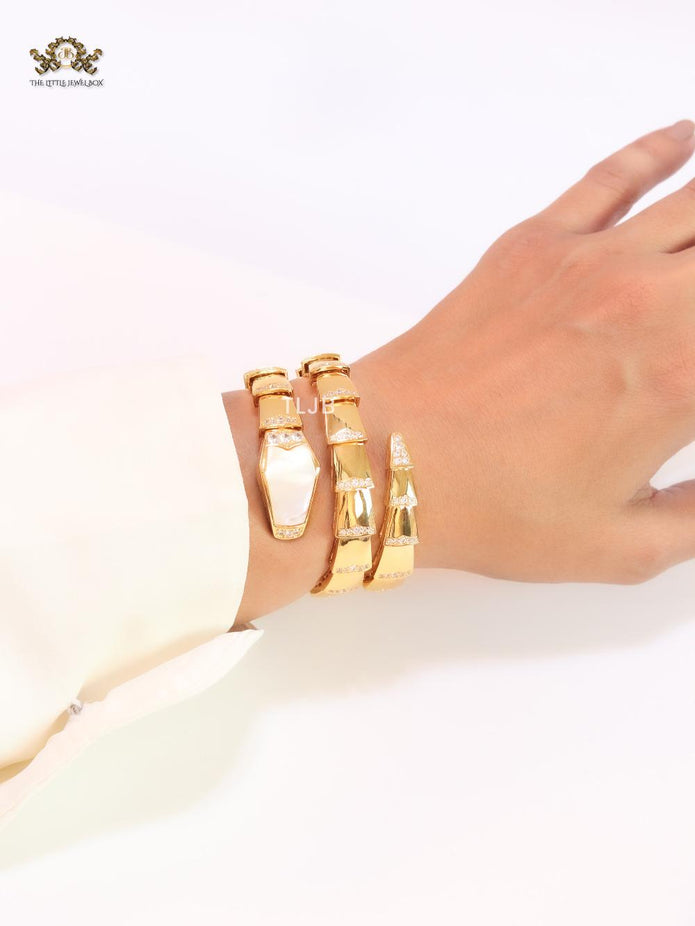Bold gold and cz snake bracelet with white mop head