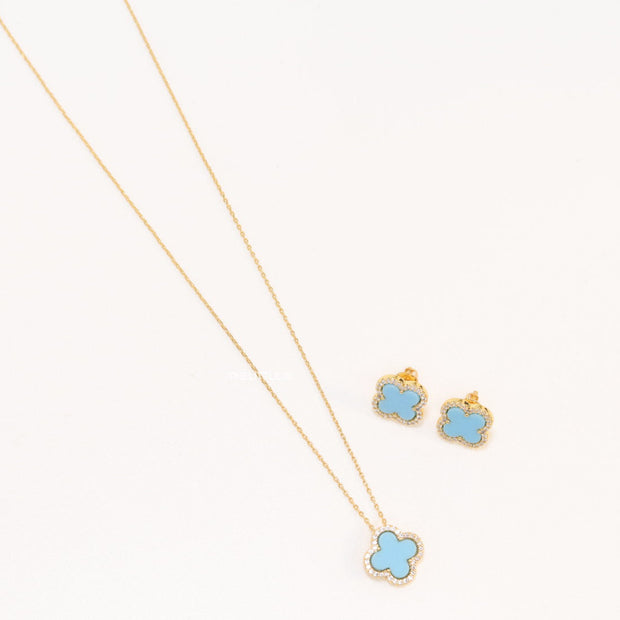 Sleek gold plated chain with cubic zirconia studded blue clover shape pendant
