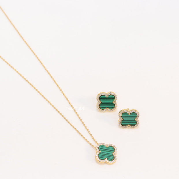 Sleek gold plated chain with cubic zirconia studded green clover shape pendant