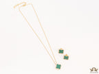 Sleek gold plated chain with cubic zirconia studded green clover shape pendant