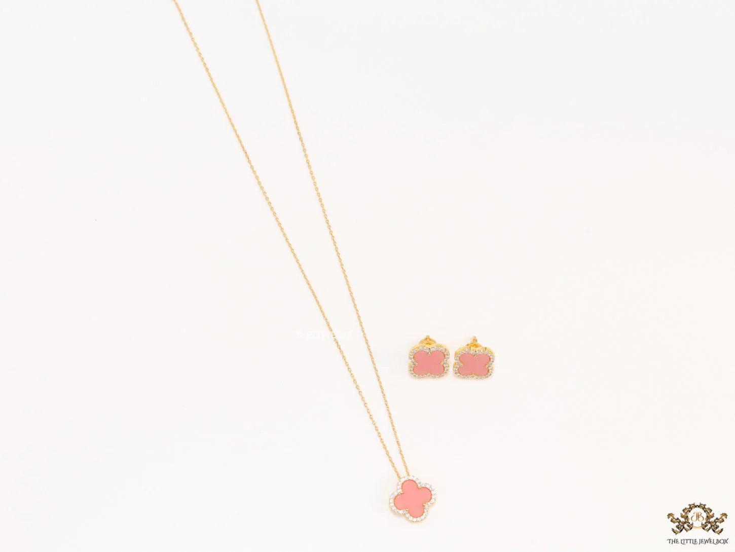 Sleek gold plated chain with cubic zirconia studded pink clover shape pendant