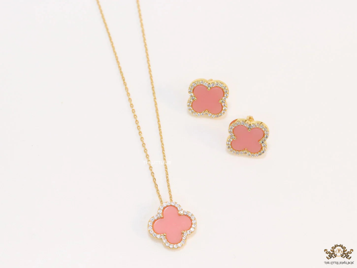 Sleek gold plated chain with cubic zirconia studded pink clover shape pendant