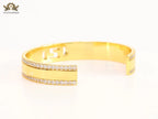 Double F on gold bracelet with cz