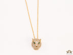 Gold plated cubic zirconia stones panther face motif pendant with emerald green stones details on sleek gold plated chain