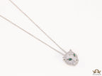 Platinum plated cubic zirconia stones panther face motif pendant with emerald green stones details on sleek Platinum plated chain