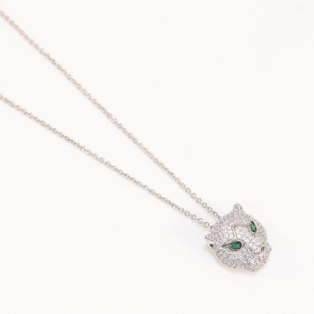 Platinum plated cubic zirconia stones panther face motif pendant with emerald green stones details on sleek Platinum plated chain